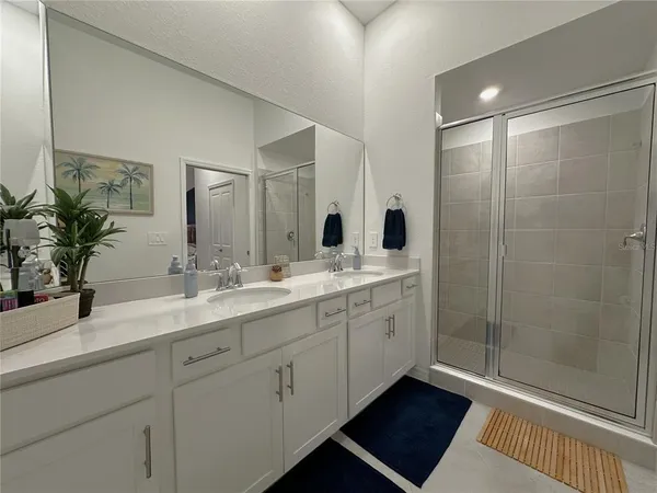 a bathroom with double sink and a mirror