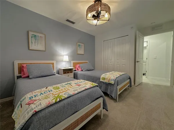 a bedroom with a bed and a chandelier