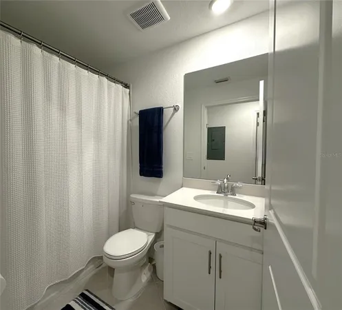 a bathroom with a toilet a sink and a mirror