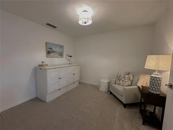 a bedroom with a bed and a lamp