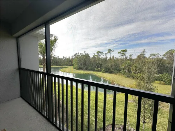 a front view of a house with garden and trees