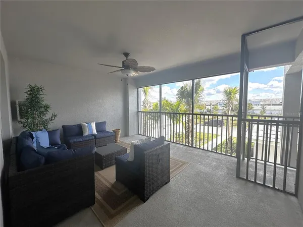 a living room with furniture and a floor to ceiling window