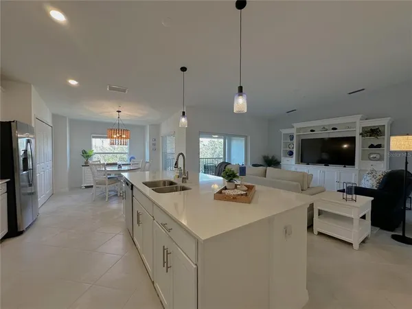 a kitchen with sink stove and refrigerator