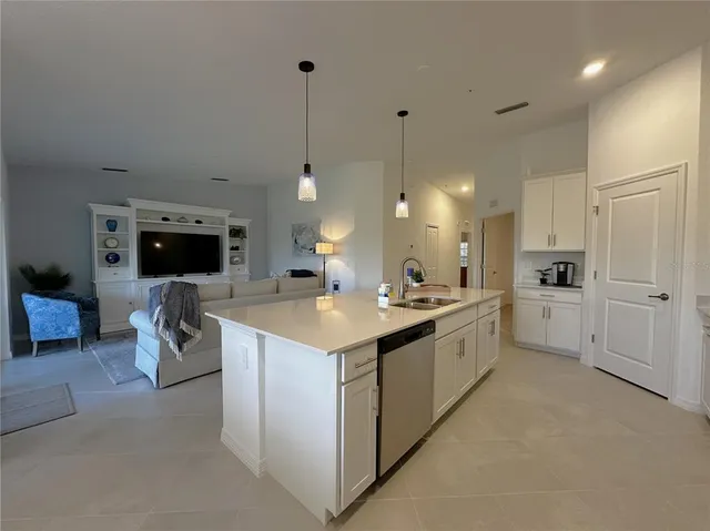 a kitchen with white cabinets and white appliances
