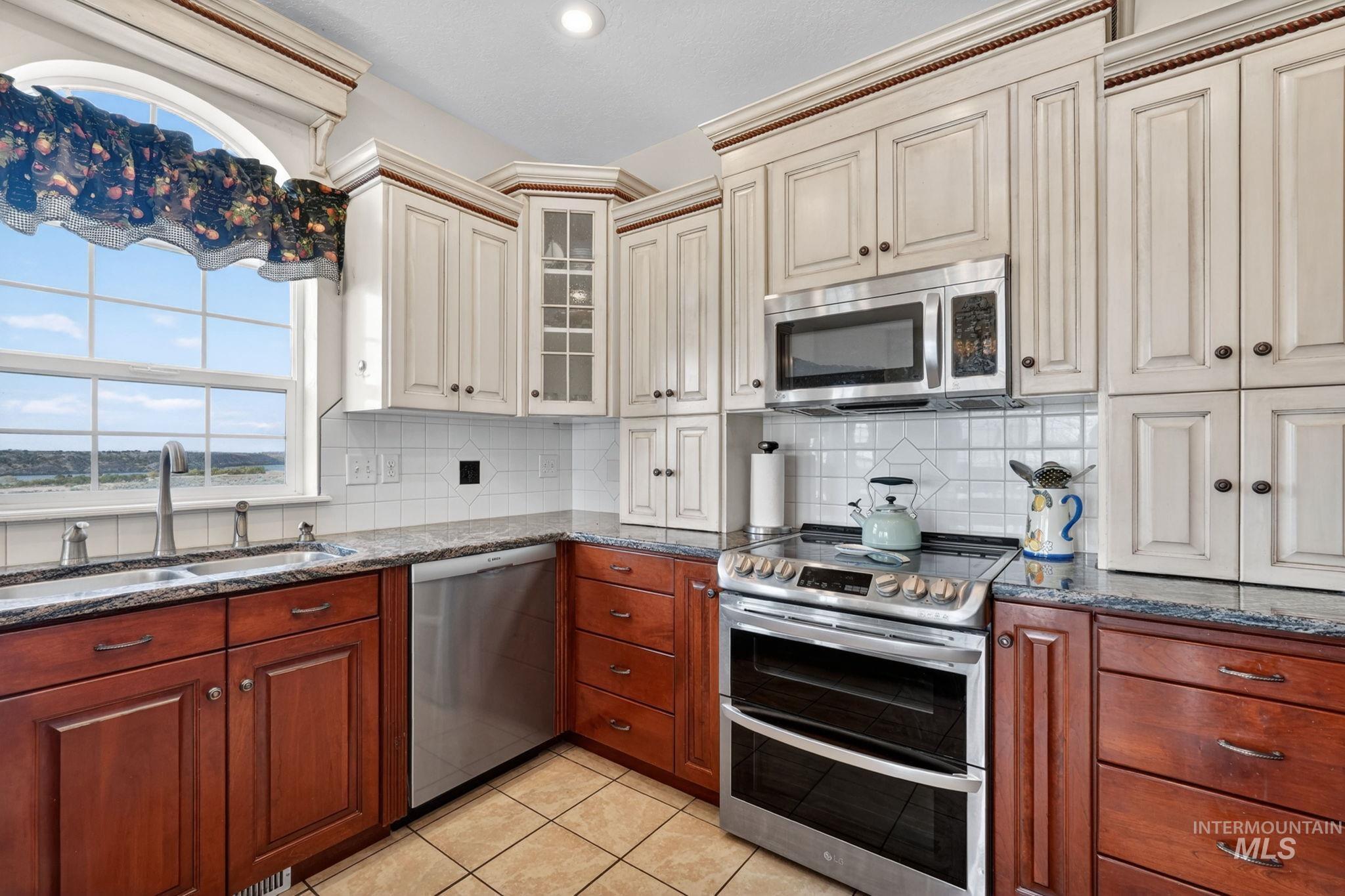 3352 Neeley Road American Falls, ID 83211 - Photo 11 of 43 Kitchen featuring a stainless steel double oven range, stainless steel microwave, and stainless steel dishwasher
