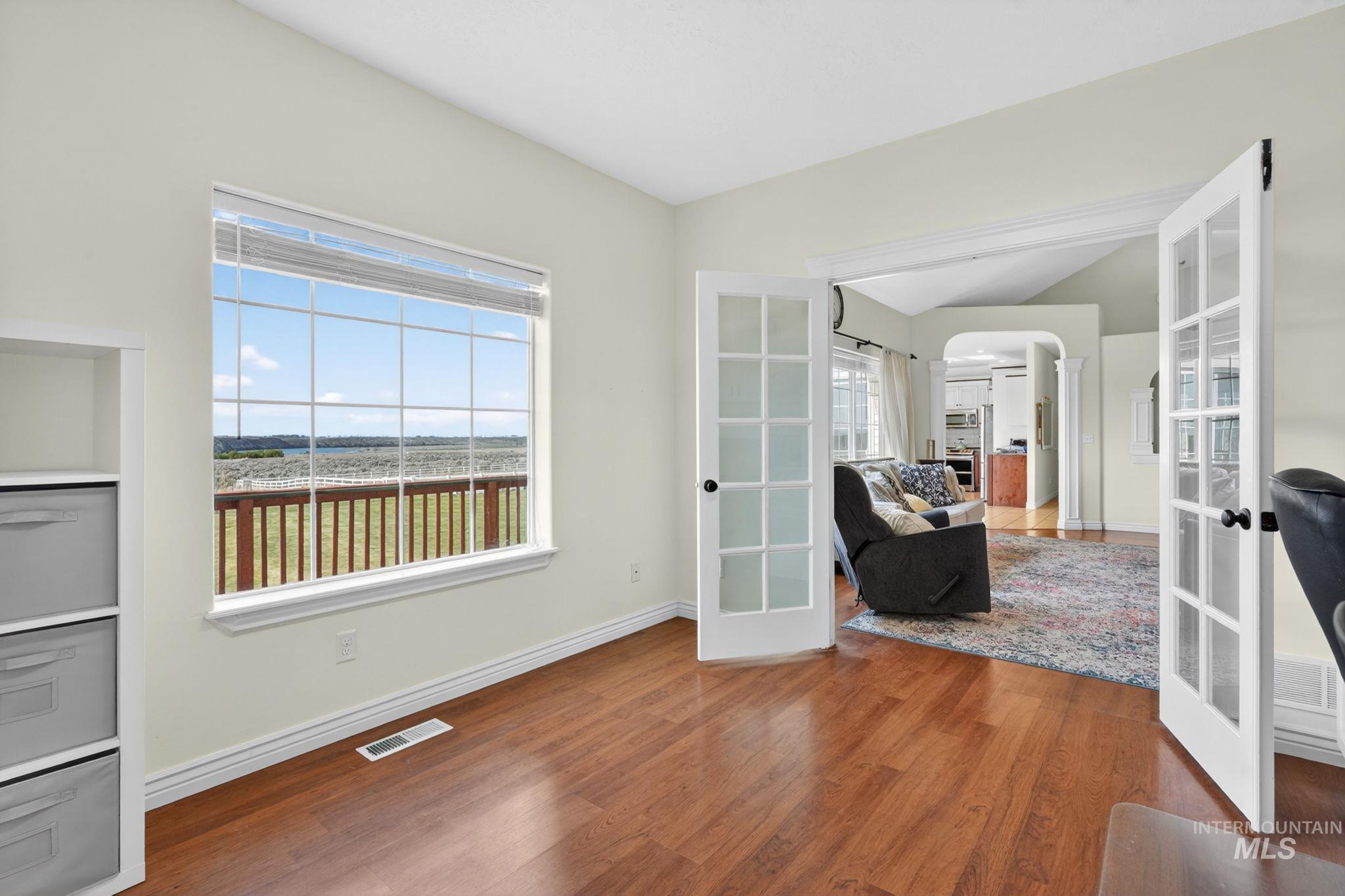 3352 Neeley Road American Falls, ID 83211 - Photo 14 of 43 Room with wood-finish flooring, featuring a large window with white framing and integrated blinds