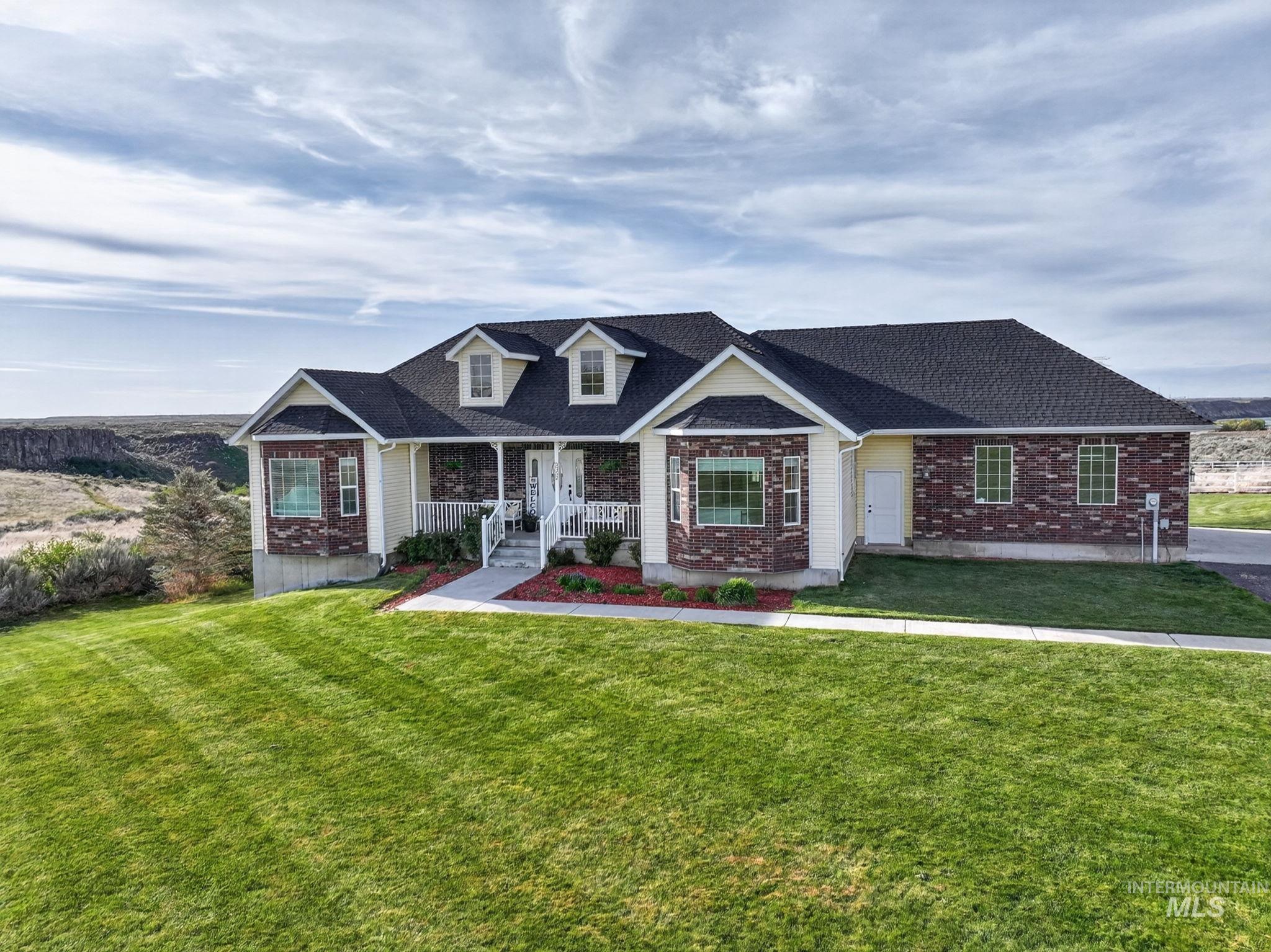 3352 Neeley Road American Falls, ID 83211 - Photo 2 of 43 Exterior featuring a partial brick facade, light-toned siding, and a covered porch with white railings