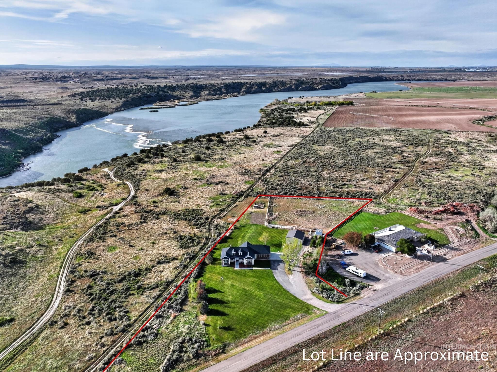 3352 Neeley Road American Falls, ID 83211 - Photo 35 of 43 Expansive property featuring a riverfront setting, two distinct structures, a manicured lawn, and a paved driveway