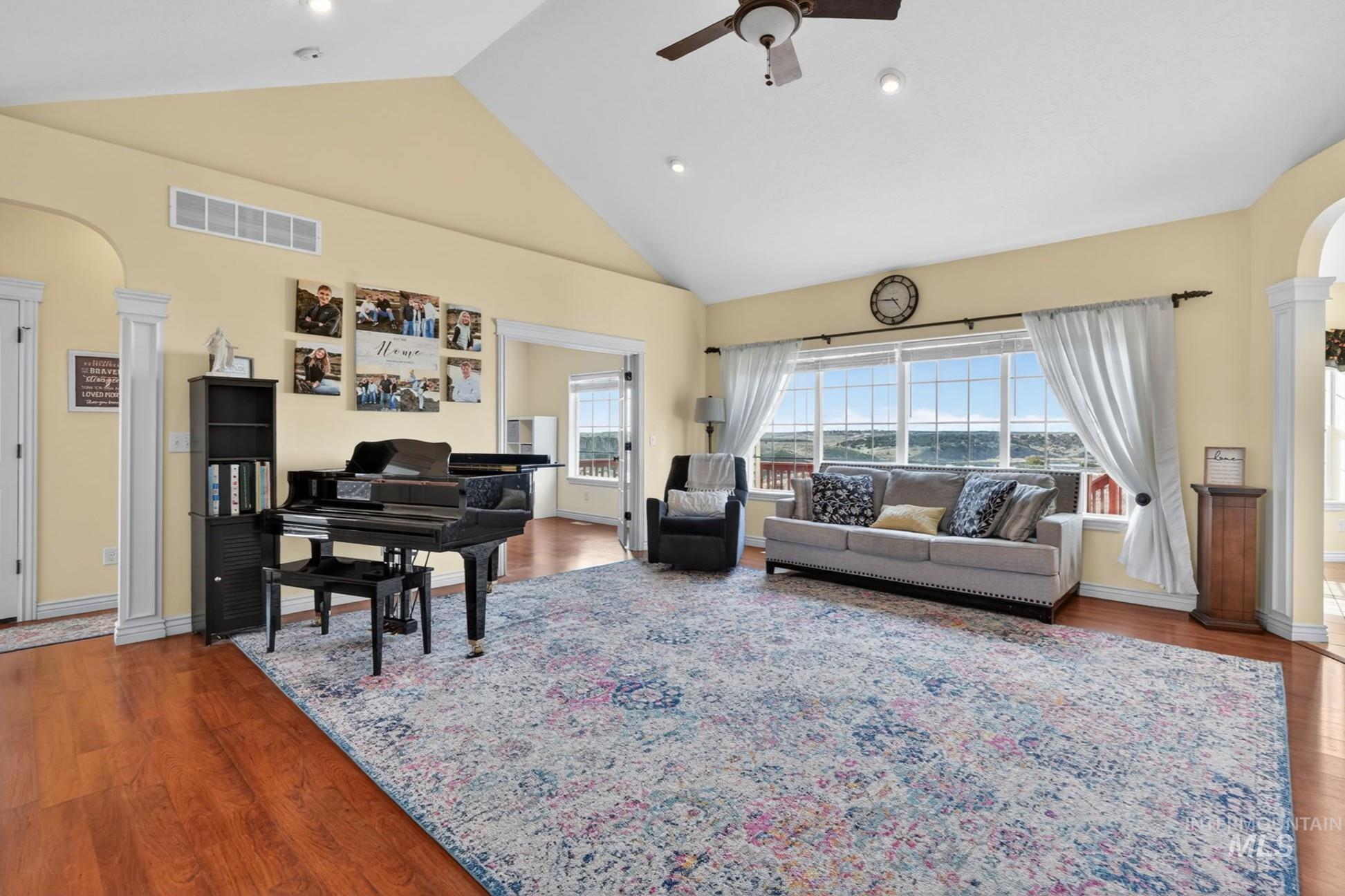 3352 Neeley Road American Falls, ID 83211 - Photo 5 of 43 Spacious living area featuring wood-finish flooring, vaulted ceilings, and large windows