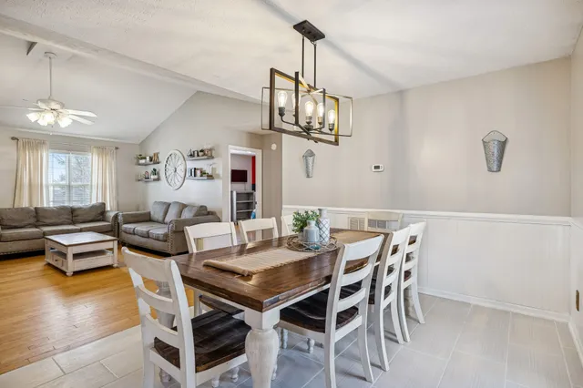 a view of a dining room with furniture wooden floor and chandelier