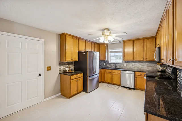 a kitchen with a refrigerator and a sink