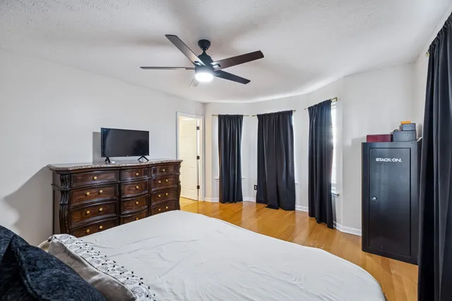 a bedroom with a bed and a flat screen tv