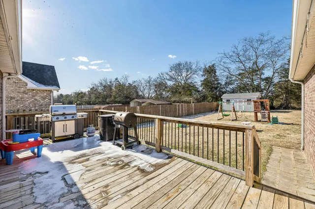 a view of a roof deck with wooden floor and barbeque oven