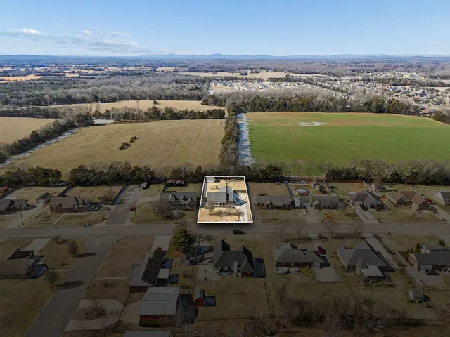 an aerial view of a houses with ocean view