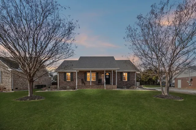 a front view of a house with a garden