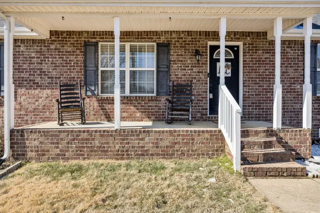 a view of a door with a brick wall