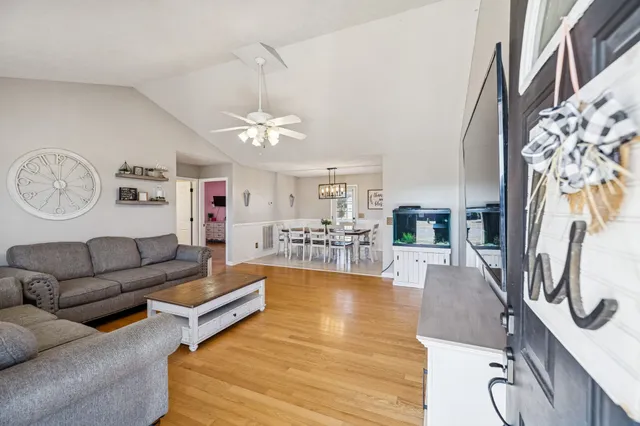 a living room with furniture and a chandelier