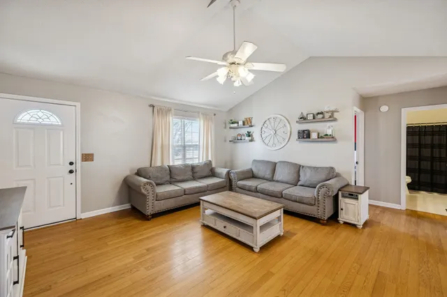 a living room with furniture and wooden floor