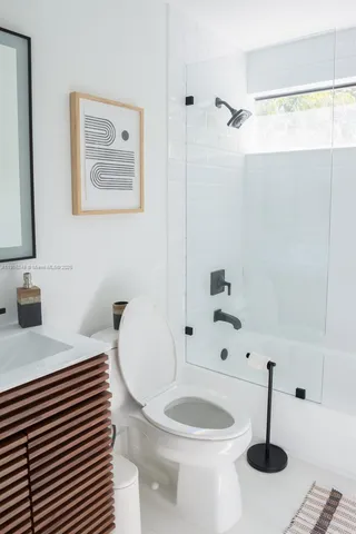 a bathroom with a sink a toilet and a shower