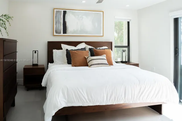 a bedroom with a bed and a painting on the wall