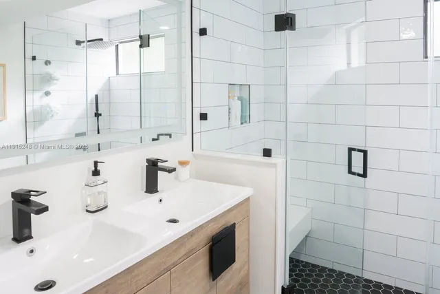 a bathroom with a sink double vanity and shower