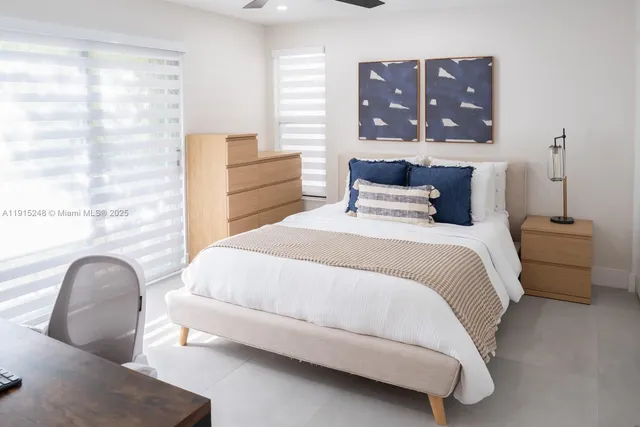 a bedroom with a bed and cabinet