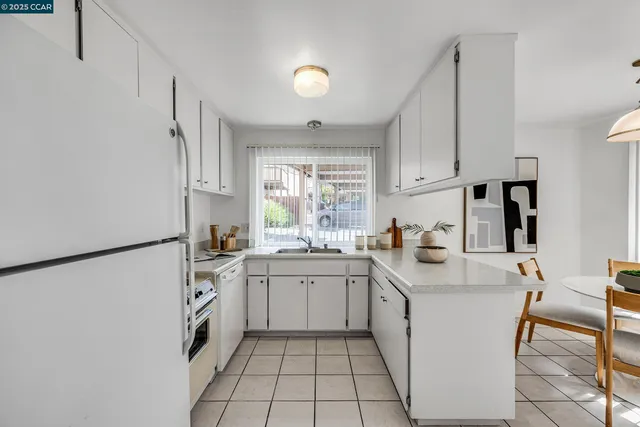 a kitchen with stainless steel appliances a sink and cabinets