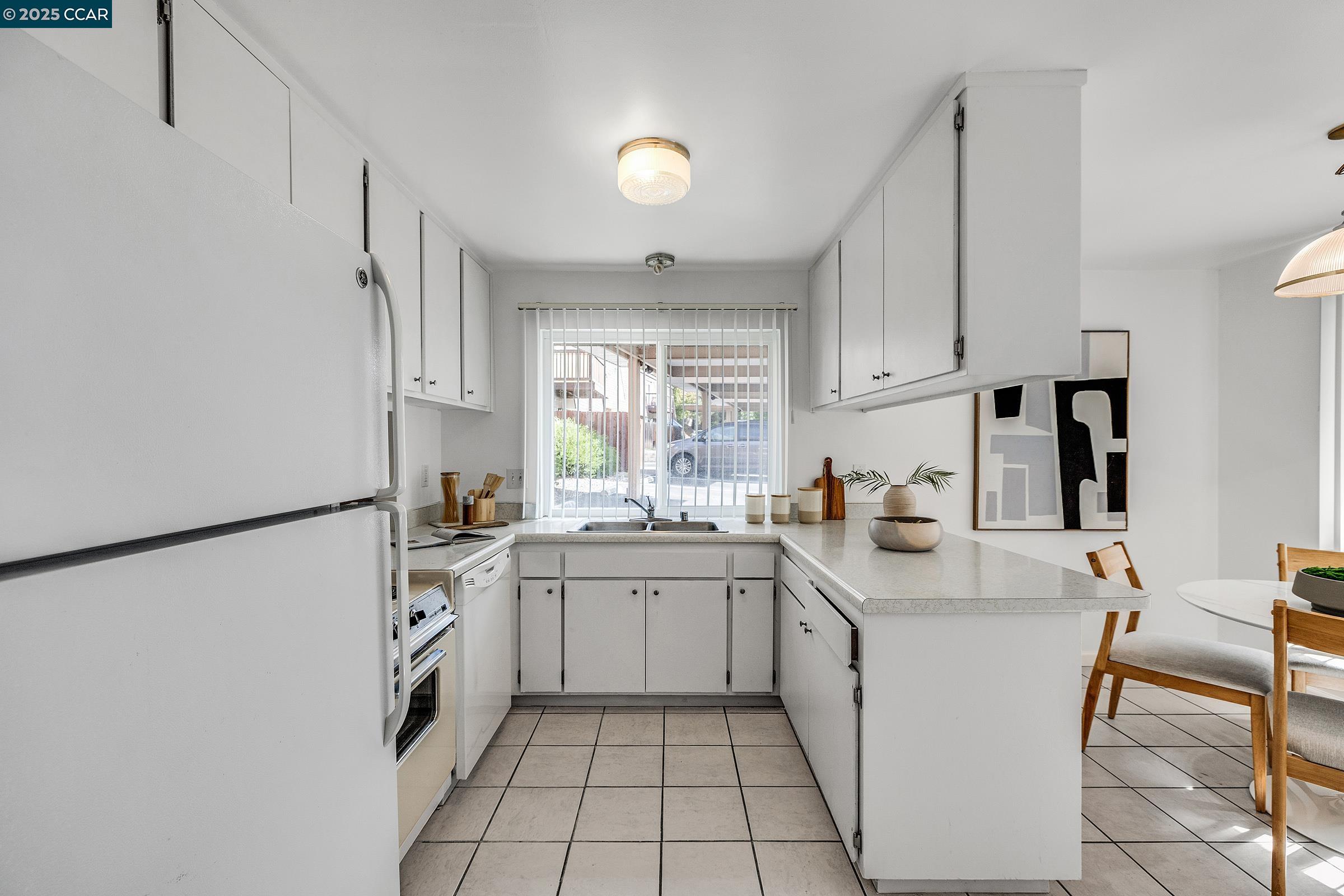 146 Ascot Court, Unit 2 Moraga, CA 94556 - Photo 13 of 33 a kitchen with a sink a stove a refrigerator and cabinets