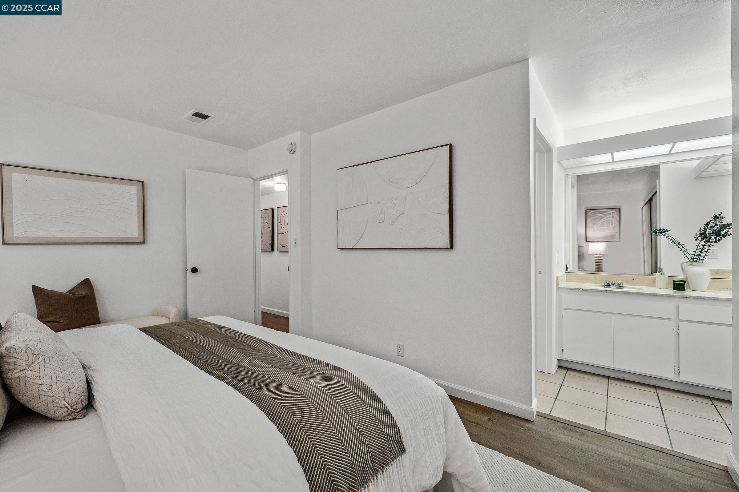 146 Ascot Court, Unit 2 Moraga, CA 94556 - Photo 16 of 33 a bedroom with a bed and a chandelier