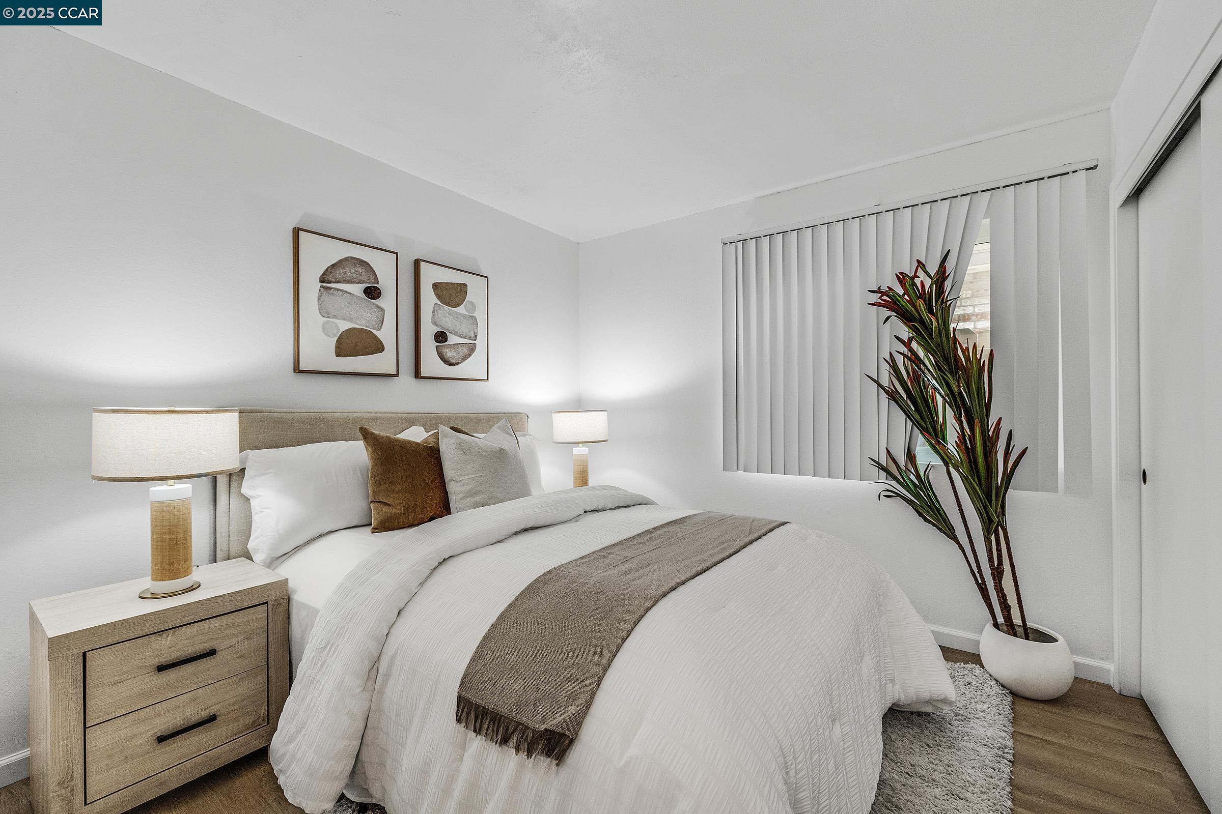 146 Ascot Court, Unit 2 Moraga, CA 94556 - Photo 20 of 33 a bedroom with a bed and a painting on the wall