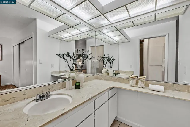 a bathroom with a glass shower door and a mirror
