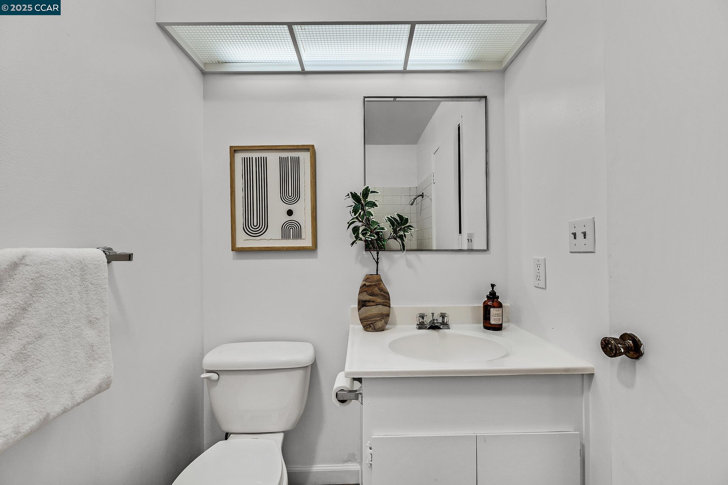 146 Ascot Court, Unit 2 Moraga, CA 94556 - Photo 27 of 33 a bathroom with a toilet sink and mirror