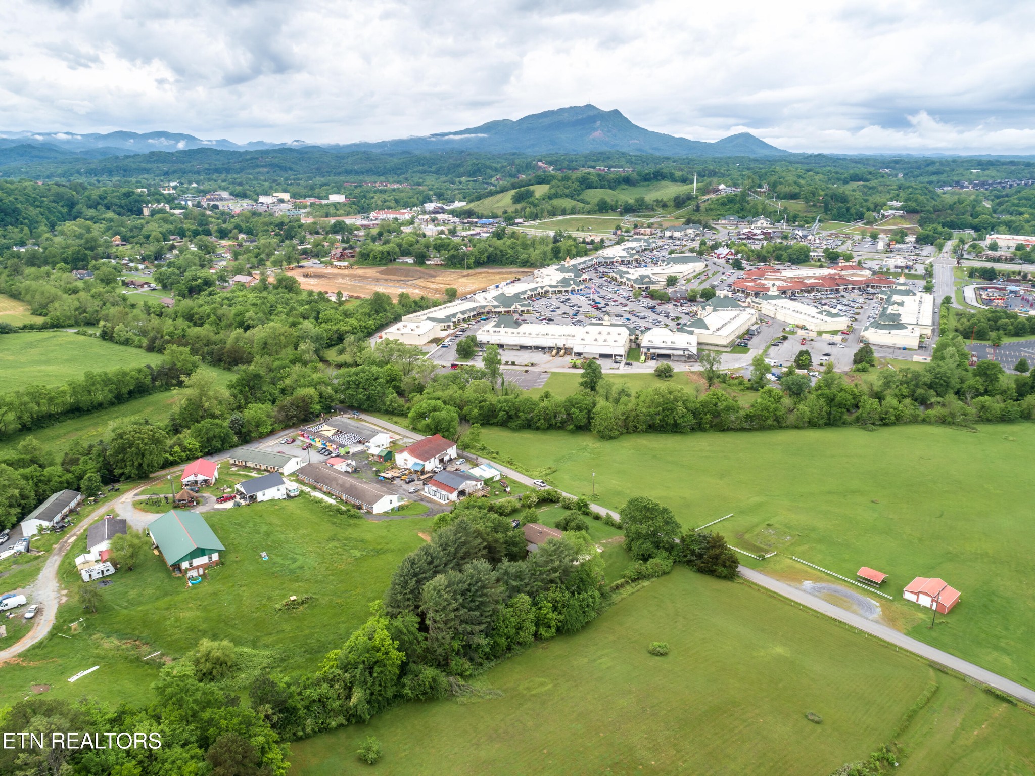 375 Rainbow Road Sevierville, TN 37862 - Photo 58 of 58 an aerial view of green landscape with trees houses and mountain view