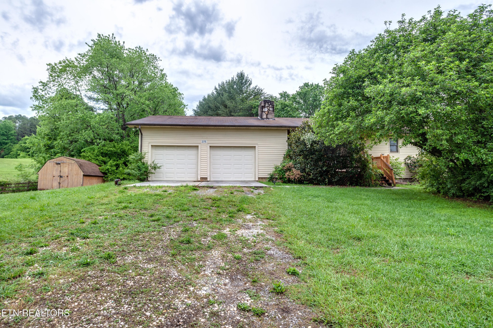 375 Rainbow Road Sevierville, TN 37862 - Photo 6 of 58 a front view of house with backyard and green space