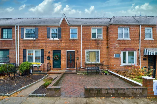 front view of a brick house with a small yard