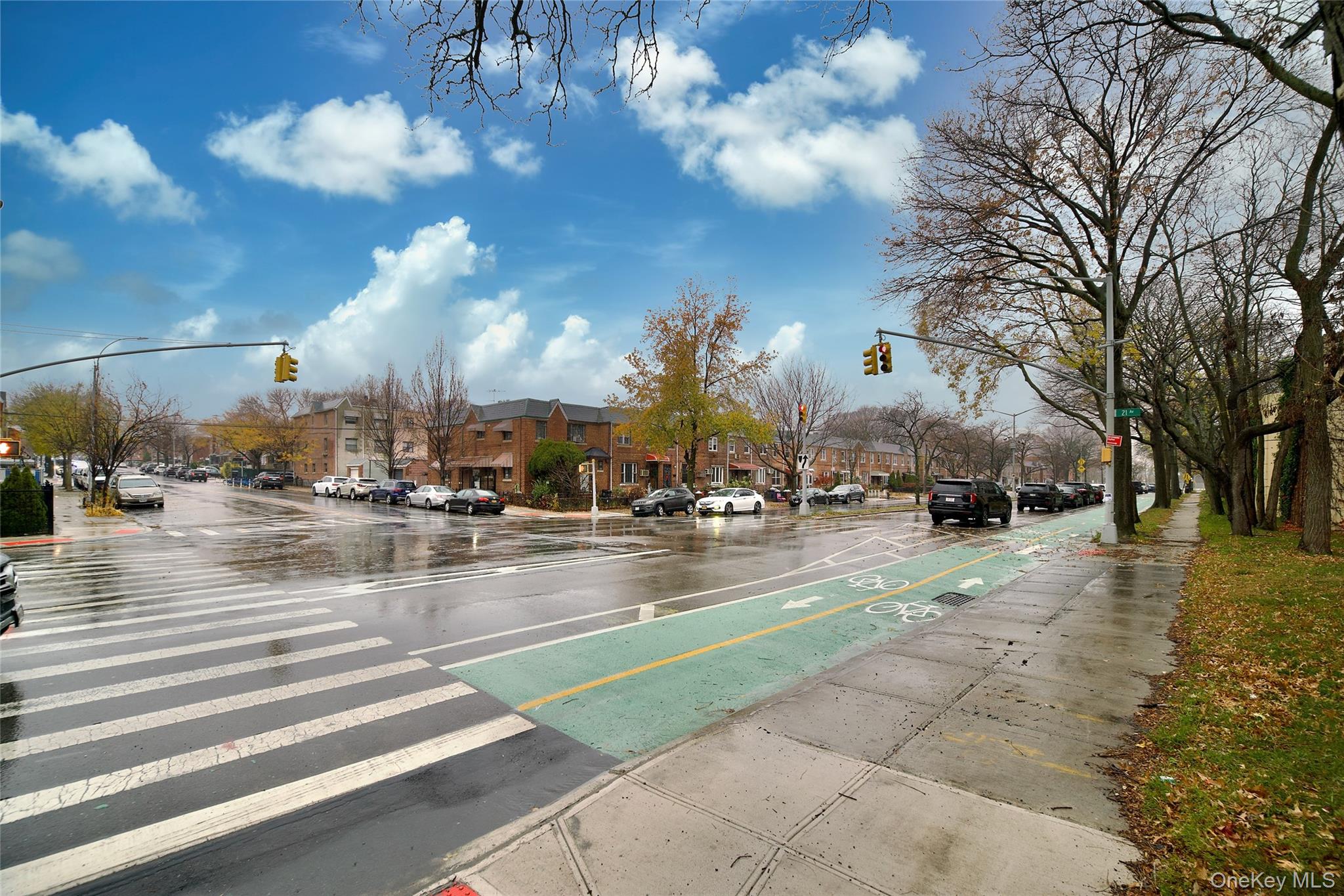 19-22 81st Street Queens, NY 11370 - Photo 8 of 10 View of asphalt street featuring traffic lights, sidewalks, and curbs