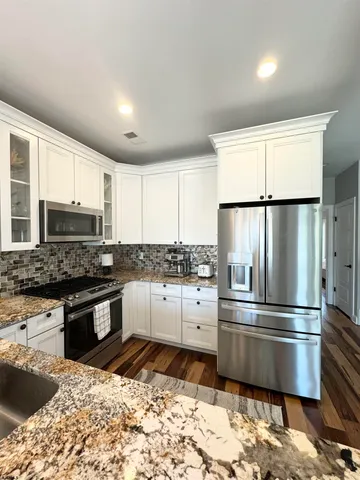 a kitchen with sink cabinets and stainless steel appliances