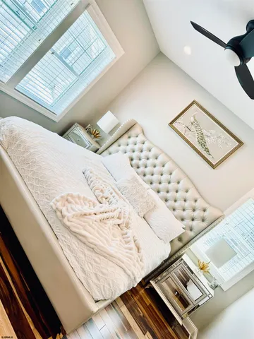 a bathroom with a double vanity sink mirror and bathtub