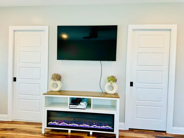 a bathroom with a sink vanity granite tub shower and a mirror