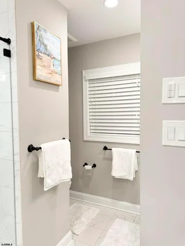 a large bed sitting in a bedroom next to a window