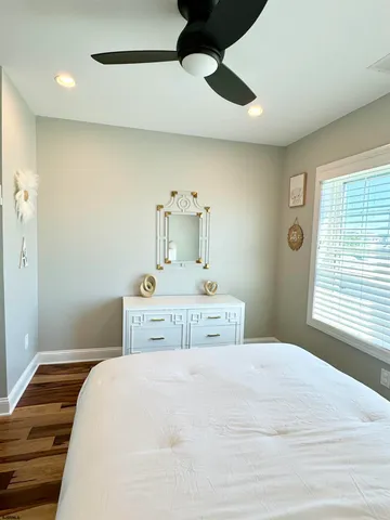 a bathroom with a granite countertop sink a toilet and a mirror
