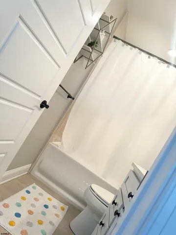 a large white bed in a small room