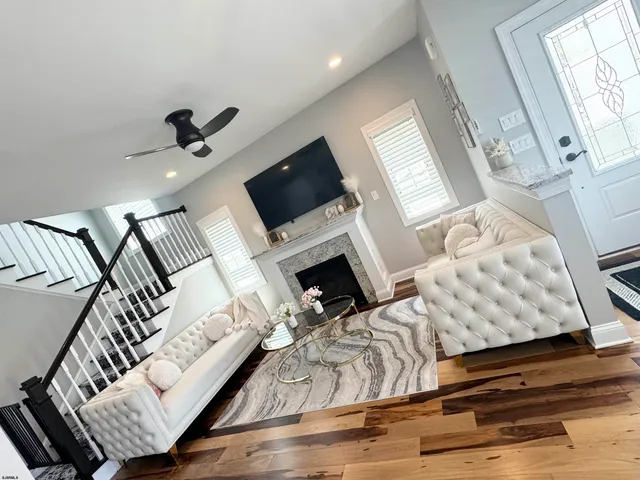 a living room with furniture fireplace and window