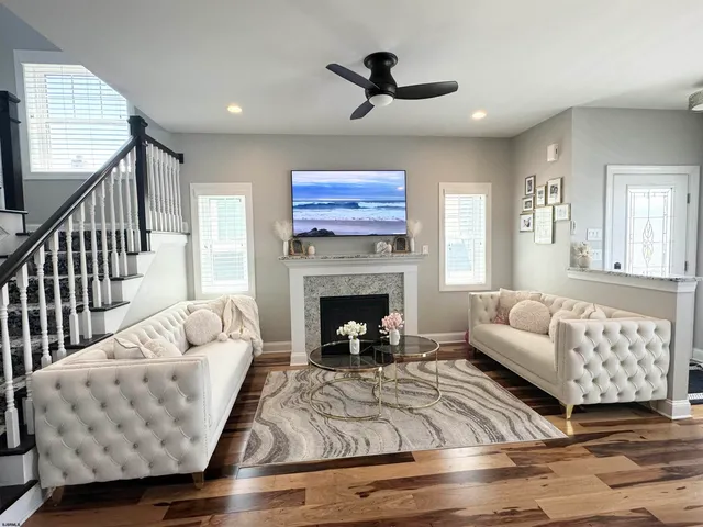 a kitchen with granite countertop a refrigerator and white cabinets