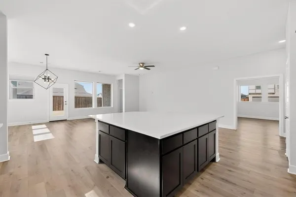 a kitchen with a cabinets and wooden floor