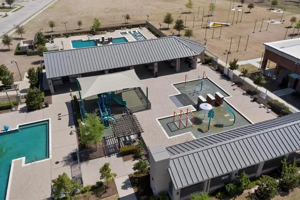 an aerial view of a house with balcony and outdoor space