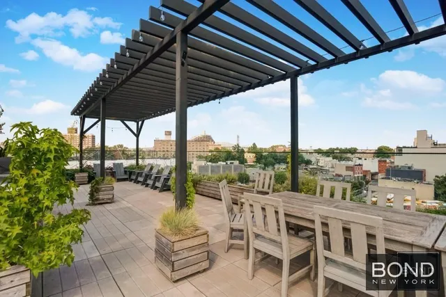 a view of balcony with chairs and potted plants