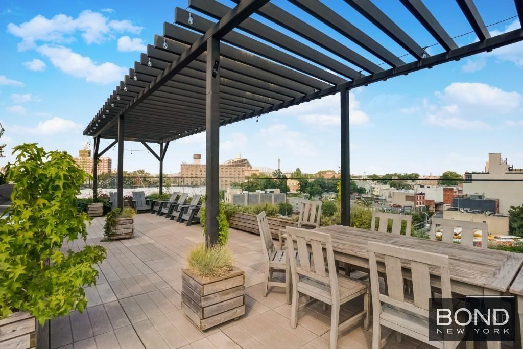 11-07 Welling Court, Unit 4B Queens, NY 11102 - Photo 7 of 7 a view of balcony with chairs and potted plants