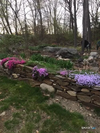 a view of a backyard with a table and chairs and a fire pit