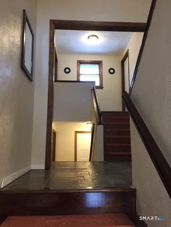 a view of entryway and hall with wooden floor